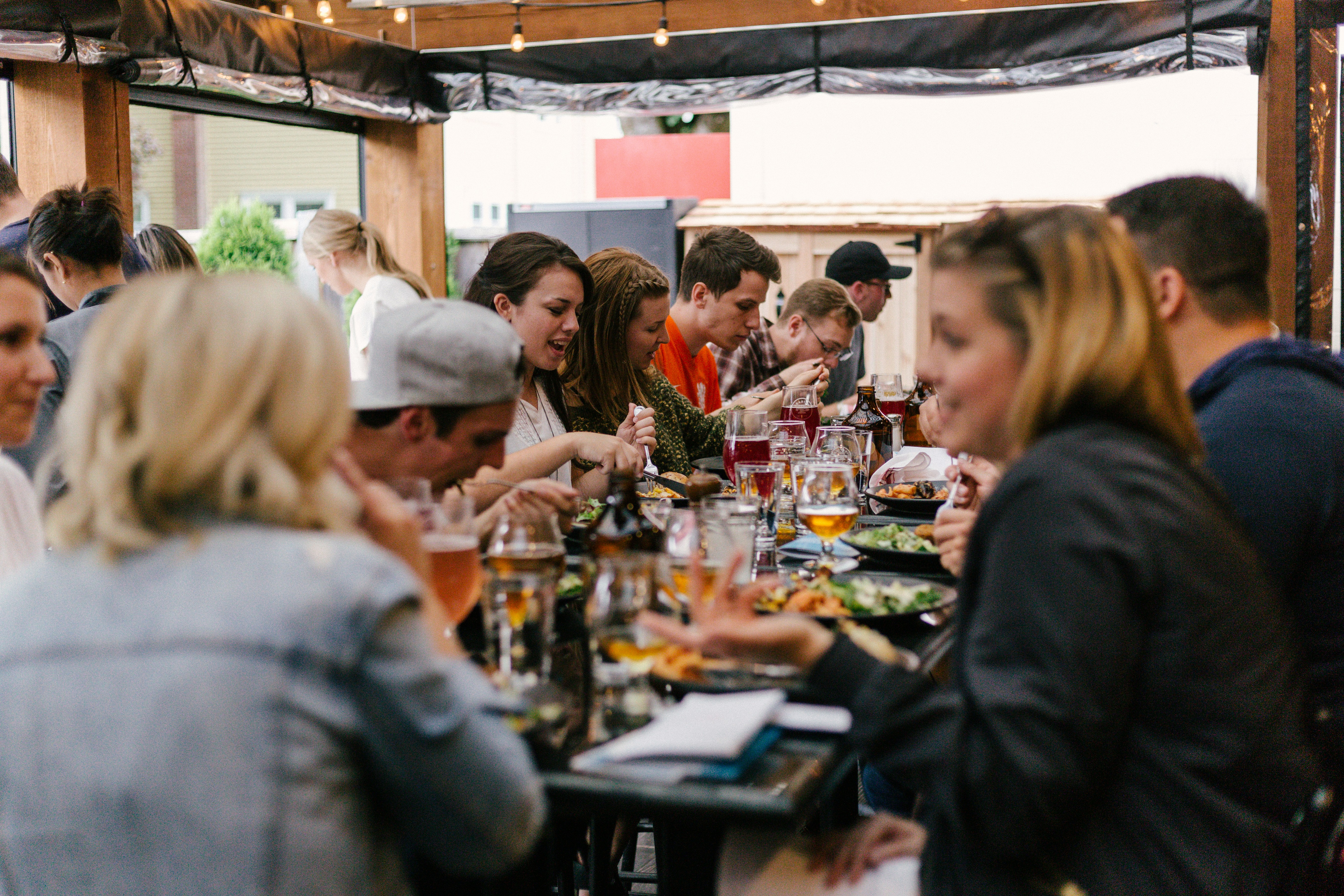 People standing around table and enjoying food together